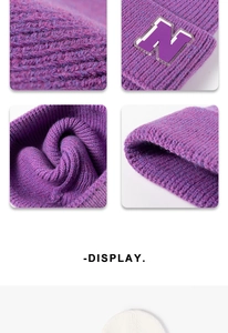Detail of purple ribbed knit beanie showing the N-logo patch and thick woven texture