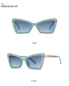 Detail view showing green cat-eye sunglasses with blue lenses and gold geometric accents