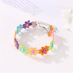 Detailed macro view of colorful hand-stitched floral embroidery with silver lobster clasp
