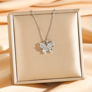 Elegant double-layered butterfly pendant necklace with zircon stones on gold silk background