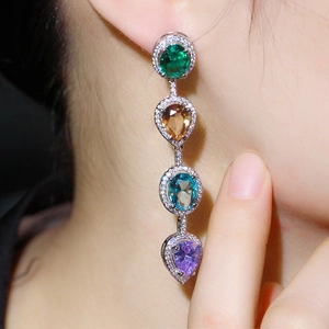 Detail of drop tassel earrings with colorful crystal stones and sparkling zircon pavé