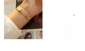 Detail view of gold celestial charm bracelet set featuring star and moon pendants
