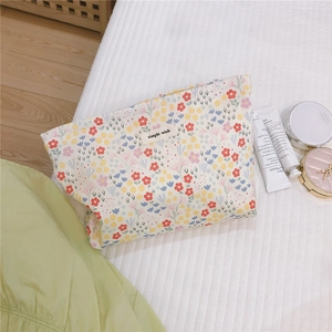 Floral canvas makeup bag with zipper detail and soft red yellow blue flower patterns