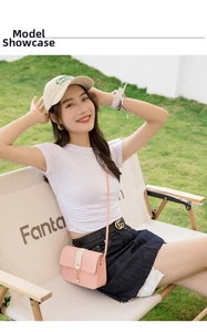 Detail of pink PU leather crossbody phone bag with pearl charm and white stripe contrast