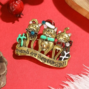 Detail of Christmas cat brooch with Friends Are The Greatest Gift engraving