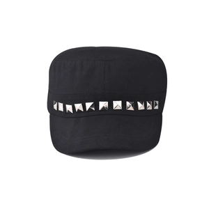 Detail view of silver pyramid studs on black cotton canvas cadet cap with punk style