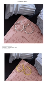 Detailed view of simple gold and silver hoop earrings from different angles