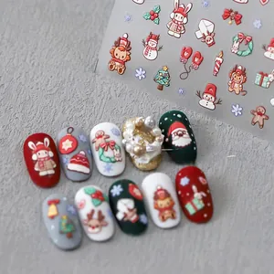 Close-up of Christmas nail art stickers featuring Santa, reindeer, and snowflakes patterns