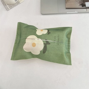 Detail of green linen tissue holder with white flowers and You are so beautiful text
