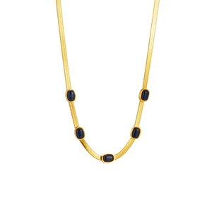 Gold flat snake bone chain necklace with five oval dark blue gemstones on white background