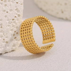 Detailed view of wide 18K gold plated mesh ring with honeycomb texture on a stone base