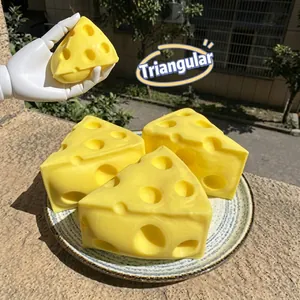 Detailed view of hand squeezing yellow triangle cheese slow rebound squeeze toy