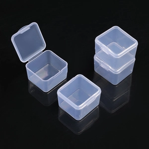 Set of 4 mini square transparent plastic storage boxes with hinged lids on black background