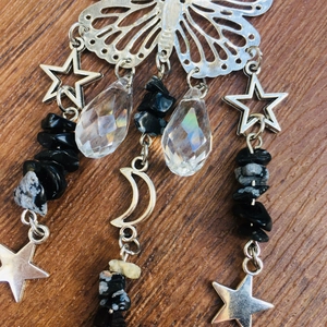 Detail of silver suncatcher with butterfly, moon stars, and black crystal stones