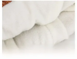 Close-up of soft white faux sheepskin fleece lining for winter baby earflap hat