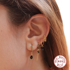S925 sterling silver gold earrings set with black zircon stones worn by a model