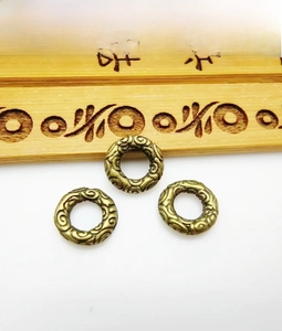 Macro detail of antique bronze spacers with auspicious cloud pattern for DIY jewelry