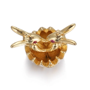 Detailed golden Easter bunny in egg charm with red gemstone eyes and white enamel base
