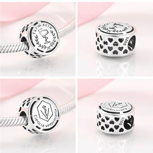 Detailed macro view of S925 sterling silver hollow beads with medical engravings