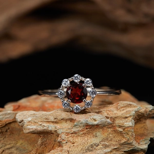 Macro shot of 925 silver garnet ring with red center stone and brilliant sparkle