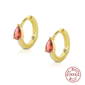 Macro view of gold-plated S925 silver hoop earring with red pear-cut stone and pavé gems