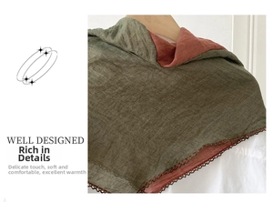 Detail of contrast stitch linen scarf showing olive green fabric and wavy crochet lace trim
