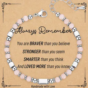 Close-up of handmade 4mm pink zebra stone beaded bracelet on a kraft paper gift card