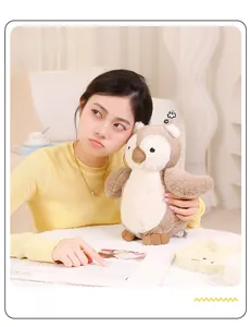 Close-up of cute owl plush toy with soft brown and white fur shown in a home setting
