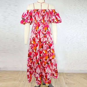 Detail of bohemian floral maxi dress with elastic smocking and off-shoulder neckline