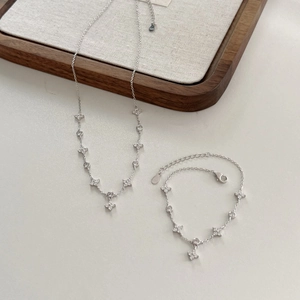 Detailed close-up of S925 sterling silver flower necklace and bracelet set with zircons