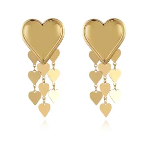 Detail of 18k gold plated heart tassel earrings showing tiered metal leaf layers