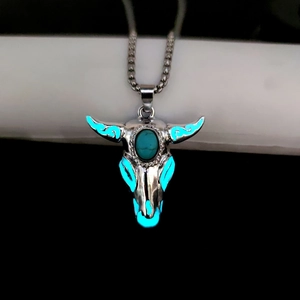 Glow-in-the-dark bull skull pendant with blue luminous eyes and turquoise stone detail