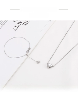 Detailed macro view of S925 sterling silver heart necklace and bracelet set jewelry