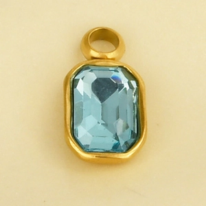 Macro shot of 304 stainless steel gold pendant with a rectangular blue glass gem