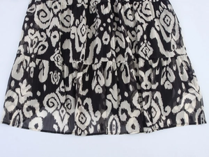 Detailed close-up of ethnic print chiffon skirt hem with tiered ruffle design
