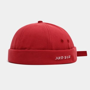 Close-up of red canvas miki hat with white Russian hip-hop embroidery and fabric texture
