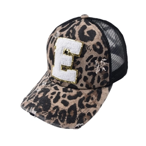 Detail of leopard print trucker hat with distressed fabric and white towel embroidery E