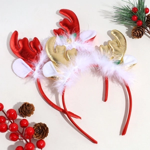 Close-up of three plush reindeer antler headbands with white feathers and festive decor