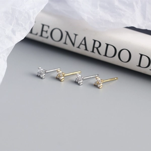 Macro shot of silver and gold S925 sterling silver four-leaf flower stud earrings with zircons