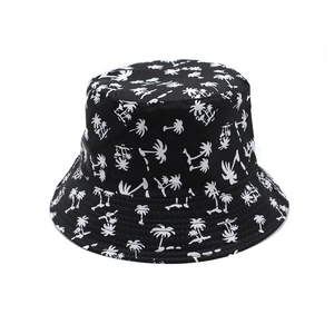 Reversible bucket hat with white coconut tree print on black fabric for outdoor sun protection