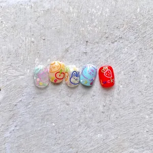 Detail of 5-piece nail stickers set featuring hand-drawn cats, rabbits and fruit patterns