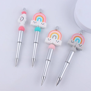 Set of four DIY beadable pens featuring colorful rainbow and smiling cloud silicone toppers