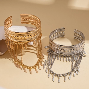 Bohemian gold and silver wide cuffs with geometric textures and feather tassels
