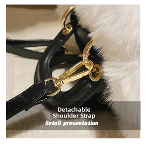 Detailed close-up of the detachable shoulder strap with a golden metal buckle and white faux fur