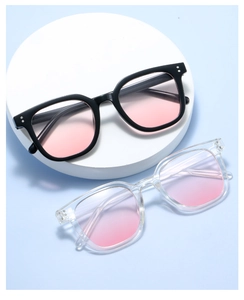 Detail of pink gradient lenses on black and transparent oversized square sunglasses