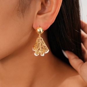 Close-up of 18K gold plated hollow mesh earrings with white pearl detail on model