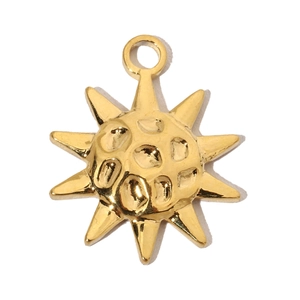 Macro detail of a golden sun-shaped titanium steel pendant with sunburst ray texture