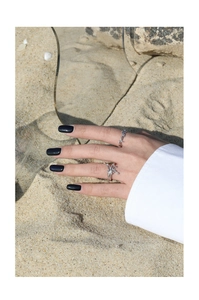 Artistic S925 sterling silver open ring with flowing texture shown on finger at beach