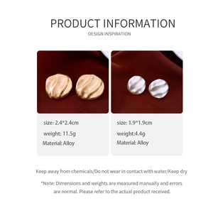 Detailed size chart for oval gold and silver textured earrings on red silk background
