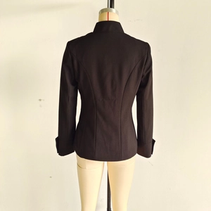 Detail view of the tailored back cut and twill texture of the black stand collar blazer